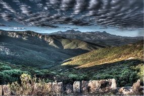 valley in the mountains under dark clouds