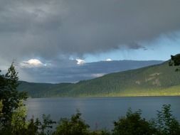 thunderstorm clouds above canim lake at summer, canada, british columbia