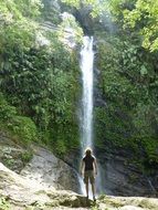 man in front of scenic waterfall among jungle, taiwan