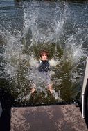 child in spray in the lake
