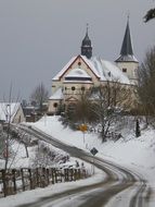 village church on hill at snowy winter