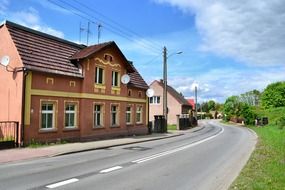 old house at asphalt road in countryside, poland, czepino