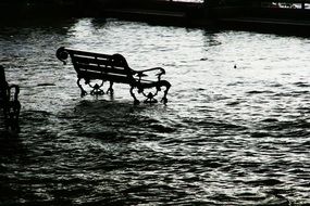 bench in the water during a flood