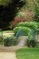 The bridge in the park near the green bushes