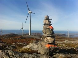 cairn against the background of a windmill