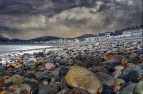A lot of the stones on the beach in Llandudno at dusk