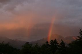 rainbow at sunset in the mountains of Austria