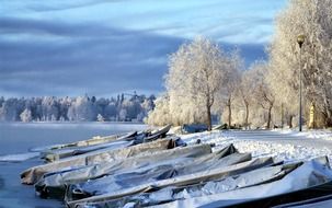 boats on the shore of a frozen lake in Finland