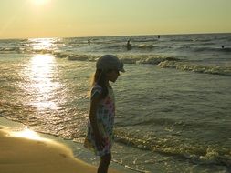 child on a beautiful beach in the evening