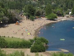 people on the beach near the forest in Spain