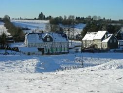 farm on a hill in winter