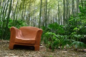 brown armchair in green forest