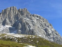 rocky mountain near the green hill