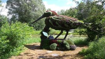 Duck sculpture made of flowers in a garden