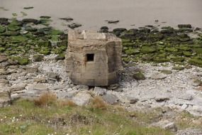 Stone grey bunker on the sea coast in France