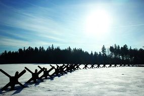 roadblocks in the snow against the background of a forest in the countryside