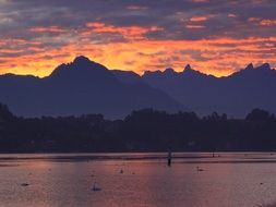 purple and orange clouds above mountains and lake, switzerland, lucerne