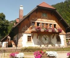 clock face on wall of traditional buildong at forest, germany, ravenna gorge