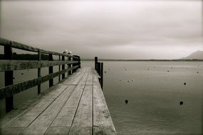 wooden pier on lake chiemsee in black and white tone