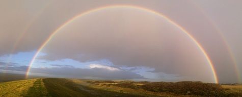 double semicircular rainbow over the island