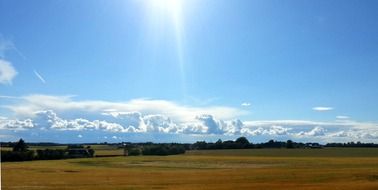 bright sun over a field in denmark