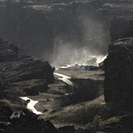 remote view of a waterfall among the rocks in iceland