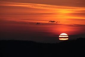 sun behind the clouds at sunset