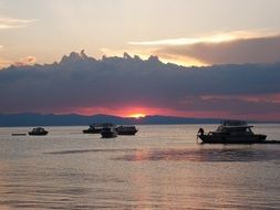 Boats in a lake at the sunset