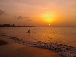 fisherman by sunset