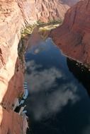 colorado river streaming through red rocks in glen canyon, usa, arizona