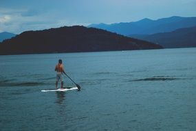 man on a surfboard on a lake