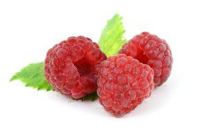 Three raspberries on a white background closeup