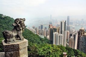 The statue on the mountain on the background of skyscrapers