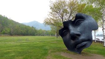 black face, modern sculpture at lake toya, japan