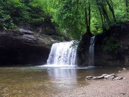low waterfall in the forest of france