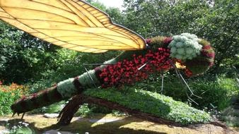 large dragonfly as a flower sculpture in the garden