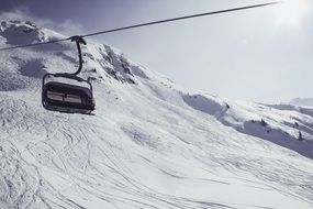 chairlift over snowy alps