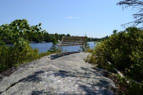 bench by the lake on a stone