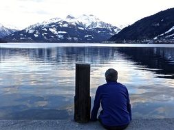 lonely man by a picturesque mountain lake