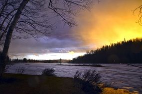 sunset over frozen lake winter landscape