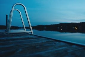 Ladder in the lake at dusk