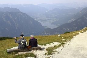 people on the bench on the mountain