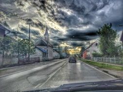 dark clouds over the road with cars