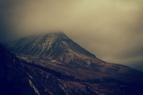clouds at dark mountain peaks