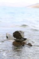 stones by the yamdrok lake in tibet