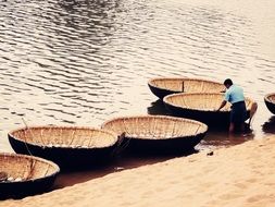 round boats on a river in India