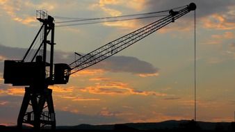 construction crane on the background of colorful clouds