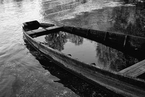 flooded boat on the river in black and white tone