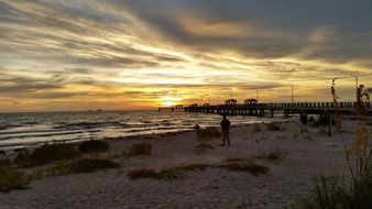 people on a tropical beach at sunset