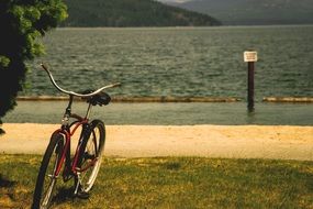 standing bicycle on a sea bank